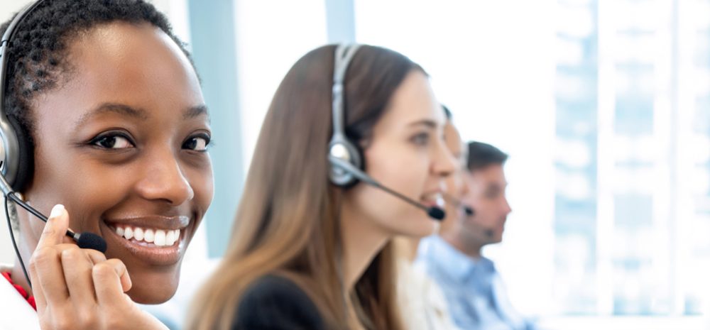 smiling-beautiful-african-american-woman-working-call-center-with-diverse-team